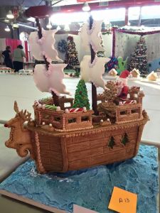Santa on a wooden ship with his Christmas tree on the deck. However, it's certainly clear he's either running this ship by magic or with an elf crew.