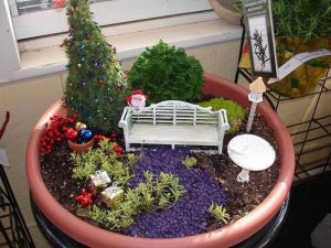 This one has presents, a tree, Santa, and baubles on a pot. Like the white bench and table though.