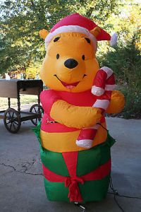 He comes out of present in a Santa hat and holding a candy cane. What's not to love?