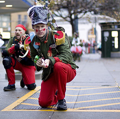 Well, at least he doesn't have a toy gun with him. But I'm not sure if his green coat goes with his read pants.