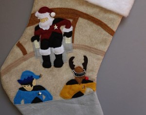 This one features Picard as Santa and LaForge with reindeer antlers. Guess they had a Christmas party before someone attacked them.