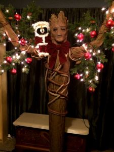 He has garlands and ornaments on his arms as well as red bow. Like Rocket dressed as Santa.