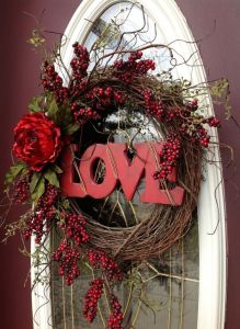 After all, it says love in wooden letters. Love the flowers and berry branches, too.