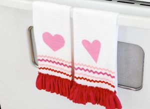 Though these seem more made for the kitchen than the bathroom. Nevertheless, they're white with pink decorations and red fringe.