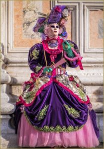 And I see she's dressed in pink and purple with flowers to boot. She even has a matching tri corner hat.