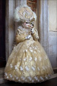 Yet, she surely shimmers in her creamy white dress. Her headdress isn't that bad either.