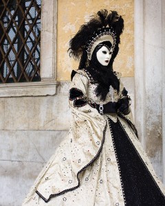 Well, the creamy white really goes with the black. Love the feather headdress.