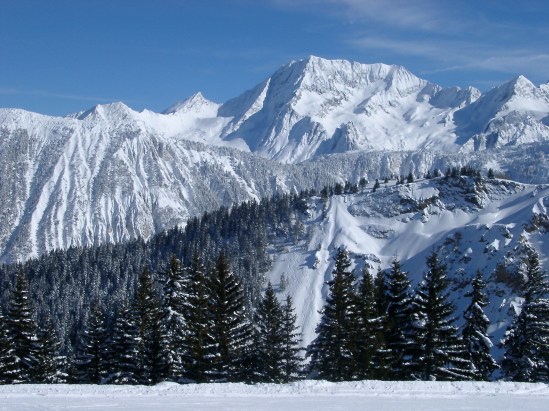 Steep Alpine mountains covered in winter snow